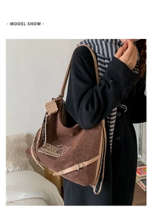 Detail view of leopard print shoulder bag with leather straps and cookie pendant