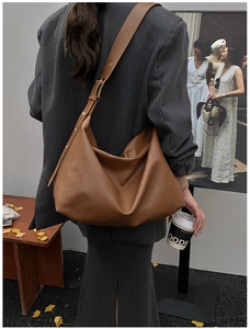 Caramel brown large hobo bag with pebbled leather texture and golden metal buckle