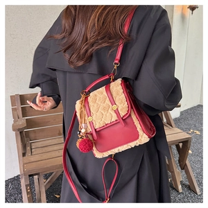 Red leather and beige shearling backpack with gold lock shown in outdoor lifestyle setting