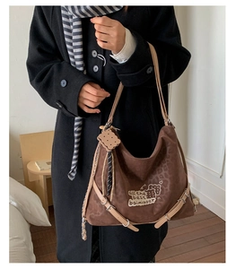 Detail of leopard print tote bag with shoulder strap and cute biscuit charm decoration