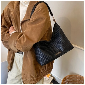 Close-up of black woven hobo bag showing intricate texture and JINHEJOYHO metal logo