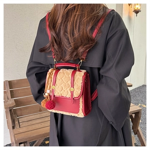 Close-up of British retro backpack with red faux fur trim and gold buckle details