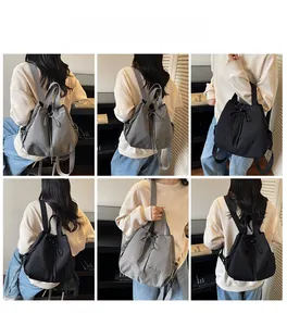 Detailed views of a grey and black canvas bucket backpack with YOU JIBEAR embroidery