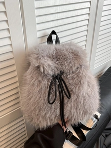 Minimalist grey faux fur backpack with black drawstring closure and nylon straps for women