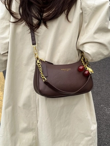 Dark brown lychee leather crescent shoulder bag with chain and cherry charm detail