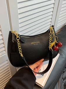 Black lychee leather hobo bag with gold chain and cherry charm decoration