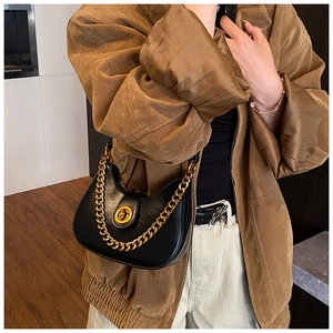 Détail du sac hobo noir avec chaîne dorée épaisse et boucle rotative métallique