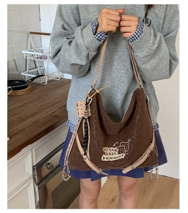 Close-up of brown leopard print tote bag with embroidery and silver chain strap details
