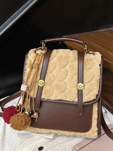 Fashionable faux fur small backpack with contrast leather details and dual plush charms
