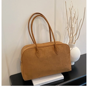Detail of caramel suede Boston tote bag with zipper and slender shoulder straps