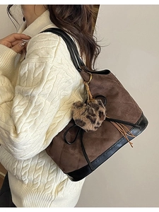 Quilted brown suede shoulder bag with leopard heart charm and black top handle