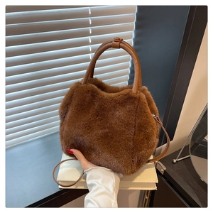 Detail of caramel faux fur handbag with leather handles and versatile shoulder strap