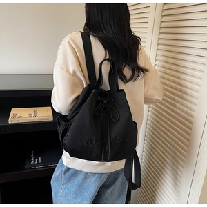 Minimalist black drawstring backpack with YOUTBEAR letters and side pocket detail
