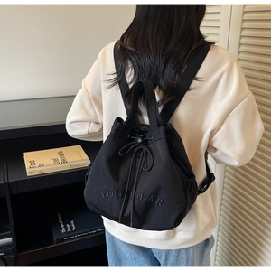 Detail of black drawstring backpack with YOUIBEAR embroidery on high quality nylon