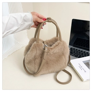 Detail of soft light brown faux fur crossbody bag with leather handles in lifestyle setting