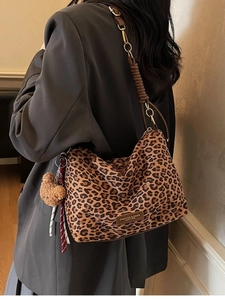 Stylish leopard print tote bag with gold chain strap and plush bear charm decoration