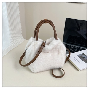 Detailed macro view of white faux fur texture with dark brown leather handle and strap
