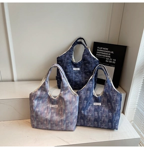 Detailed shot of textured canvas tote bags with star pattern and Kiss Yourself label