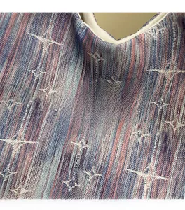Macro shot of striped denim texture and star patterns with a woven logo tag on the tote bag