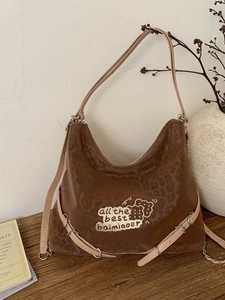 Brown suede leopard print backpack with cream straps and cute graphic embroidery