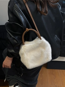 Chic white fluffy plush tote bag with brown faux leather straps for winter fashion