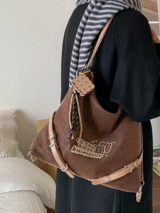 Brown leopard print large tote backpack with vintage buckle straps and cookie charm