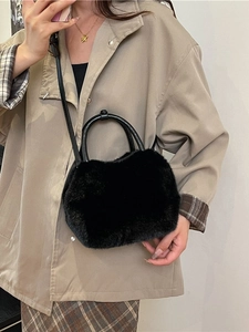 Chic black faux fur handbag with round handles and adjustable strap for winter fashion