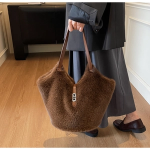 Brown faux fur tote bag detail featuring premium leather handles and silver metal clasp