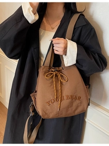 Brown canvas bucket backpack with YOUJI BEAR embroidery and drawstring closure