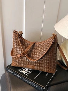 Brown woven leather shoulder bag with adjustable strap and chic retro texture design