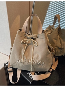 Khaki drawstring canvas backpack with You Ji Bear embroidery and adjustable straps