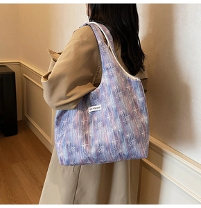 Side view of large tote bag with purple blue gradient and white star pattern detail