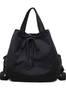 Versatile black canvas backpack with drawstring closure and YOU JA BEAR embroidery
