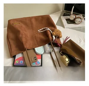Detail view of suede tote bag interior showing large capacity for laptop and daily essentials