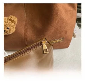 Detail of premium matte suede tote bag featuring high-quality zipper and mini bear charm