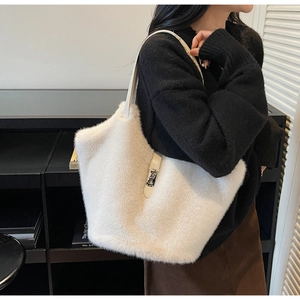 Detail of white faux fur tote bag with metallic lock and slim shoulder strap