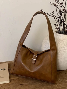 Vintage brown PU leather tote bag with a wide shoulder strap and silver buckle detail