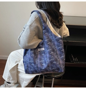 Close-up of star pattern canvas tote bag with a white woven label and soft texture