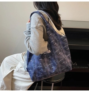 Detail of large canvas tote bag with purple star pattern and MISS YOU woven label