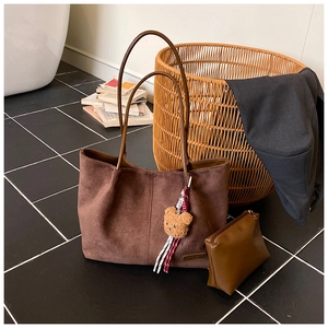 Brown faux suede tote bag with small zipper pouch and decorative teddy bear pendant