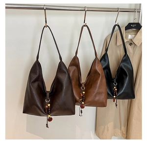 Three minimalist large capacity tote bags hanging with beaded tassels in autumn colors