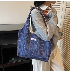 Detail of blue and purple starburst pattern canvas tote bag with side label tag