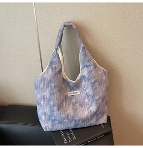 Artistic tote bag detail featuring blue purple abstract marble pattern and star accents