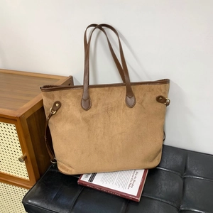 Detail of suede texture and brown leather handle on large vintage leopard tote bag