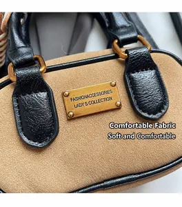 Close-up of brown frosted texture with black leather trim and golden metal logo plate
