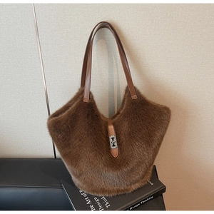 Detail of plush brown tote bag showing furry texture and metal twist lock closure