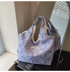 Close-up of sparkling star patterns and textured fabric on the large tote bag