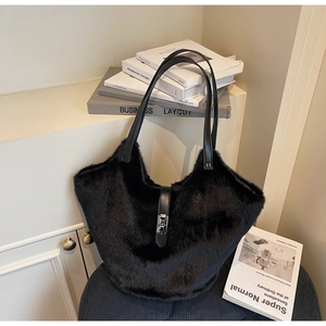 Macro detail of plush faux fur tote bag with leather straps and silver metal buckle lock