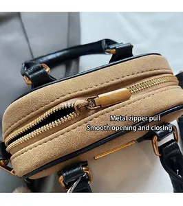 Detail of premium gold zipper and dual-tone leather stitching on Boston handbag