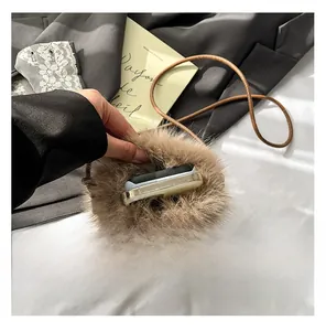 Detailed interior view of a brown plush crossbody bag showing ample smartphone capacity